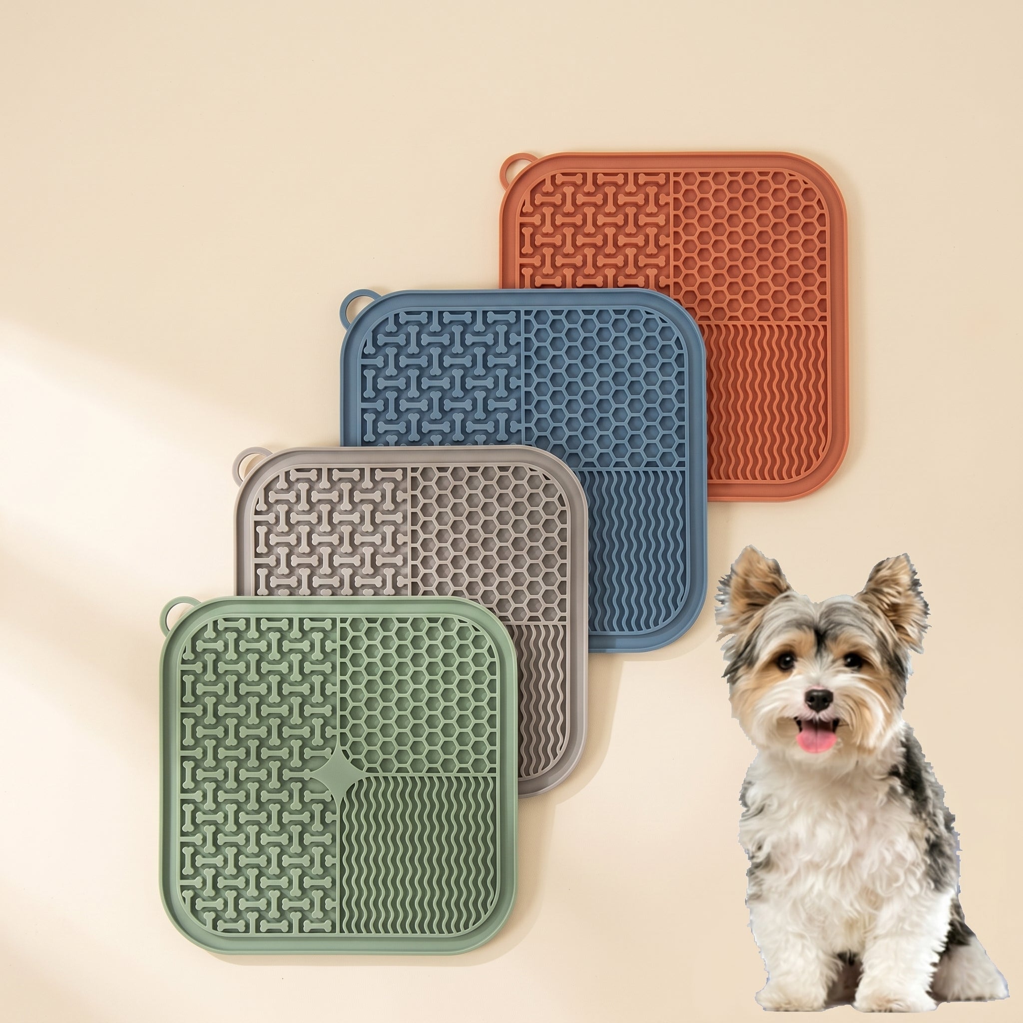 Four silicone lick mats in terracotta blue taupe and sage with textured surfaces