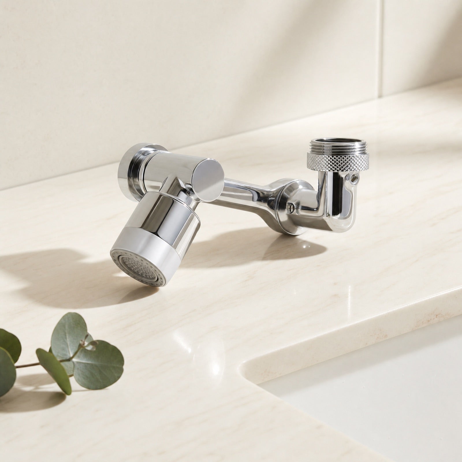 Chrome mechanical-arm faucet extender on a cream studio background
