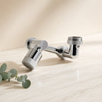 Chrome rotatable faucet aerator on a cream marble tile — Wombat Haul