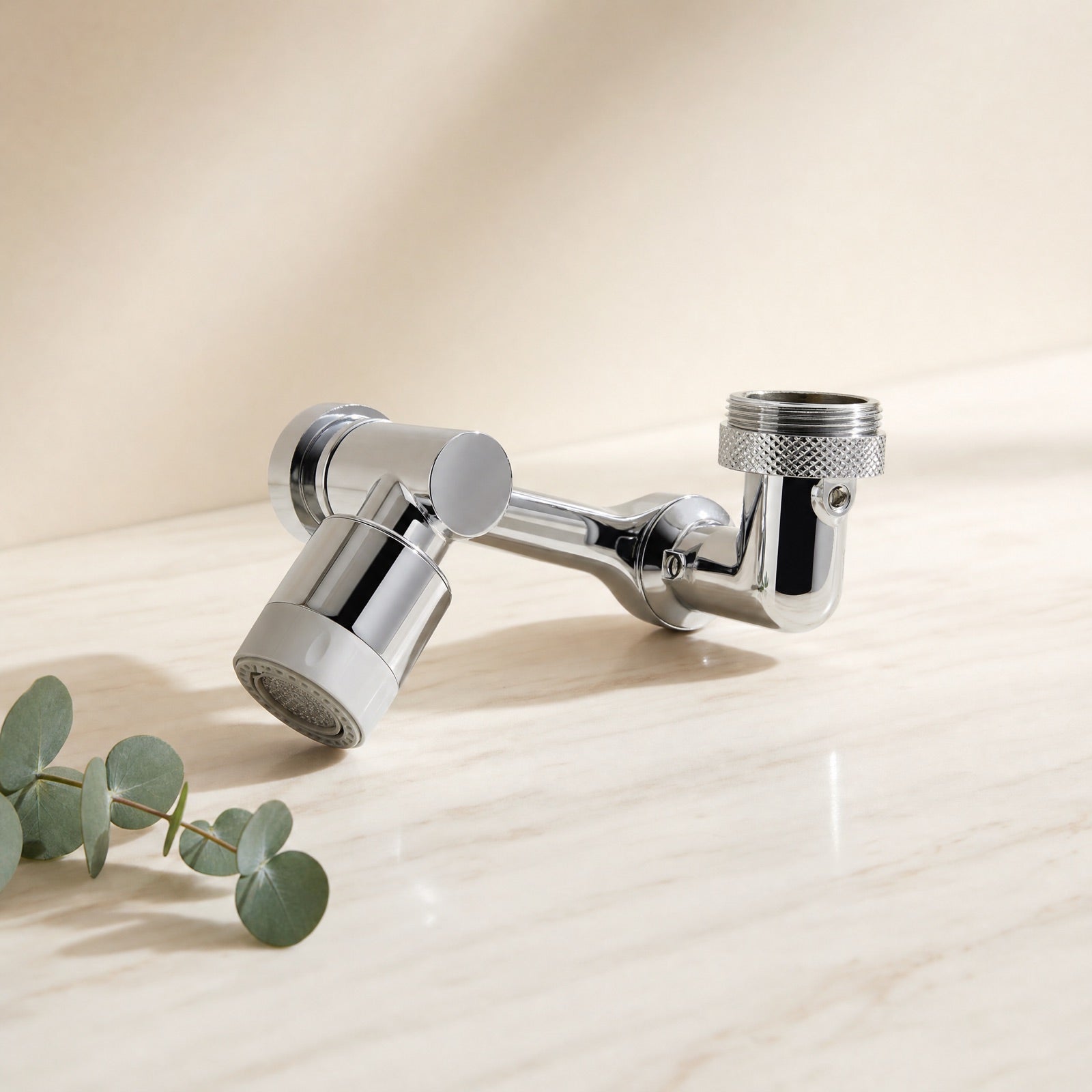 Chrome rotatable faucet aerator on a cream marble tile — Wombat Haul