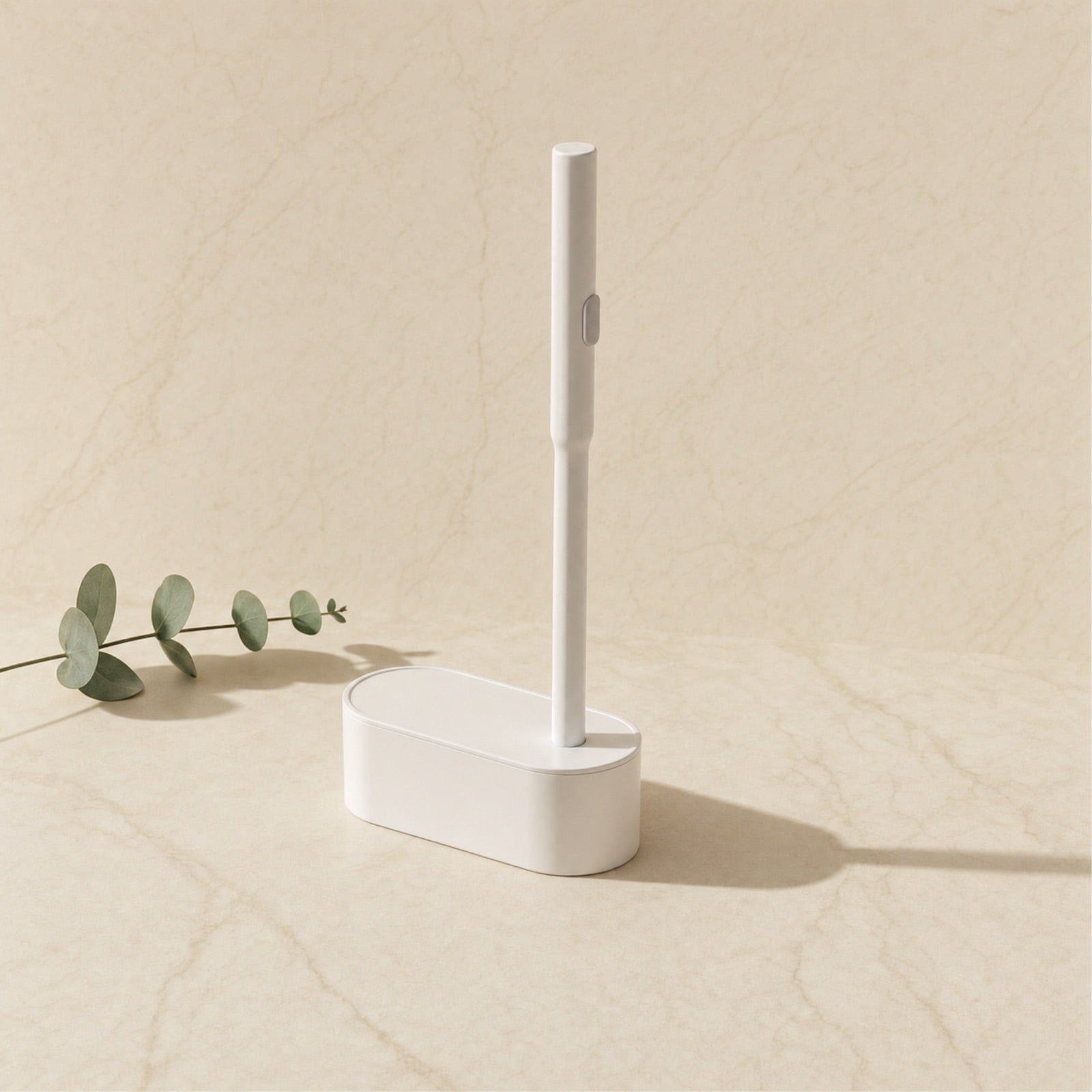 White disposable toilet brush and caddy on a cream marble tile — Wombat Haul